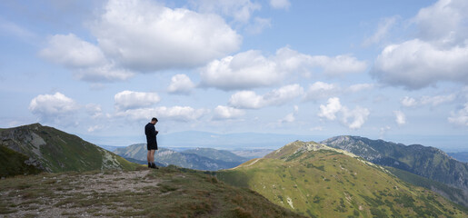 Man standing on the mountain summit enjoying the views, Slovakia, Europe