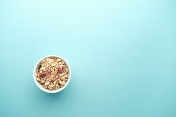 Home Made Musli in a bowl on light green background 
