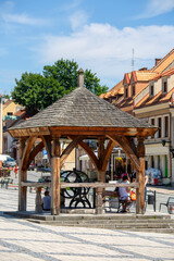 View on market with  old wooden well, Sandomierz, Poland