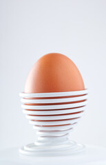 One boiled egg in a spiral-shaped metal support