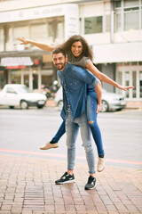 He likes to do anything with me, absolutely anything. Shot of a playful couple out in the city together.