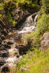 A bright, summer HDR image of Allt na h-annaite, a waterfall along Strathconon in Ross-shire, Scotland