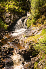 A bright, summer HDR image of Allt na h-annaite, a waterfall along Strathconon in Ross-shire, Scotland