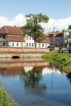 Reflection of a medieval house in the river, vertical frame, Kuldiga, Latvia. High quality photo