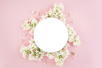 White summer lilac branches. A frame of flowers. Summer flowers on a pink background. Floristry.Top view flat lay with copy space