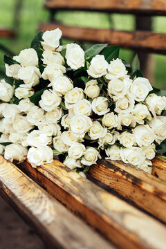 close-up of a huge bouquet of white roses on wooden bench. background of the many roses wedding, the day of St. Valentine. Copy space