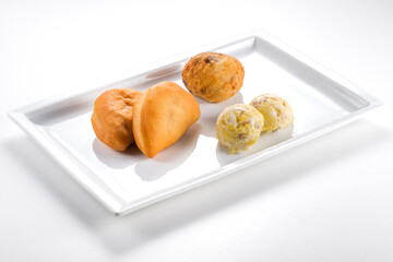 Rectangular plate with aubergine croquette sea bass souffle mini calzoni