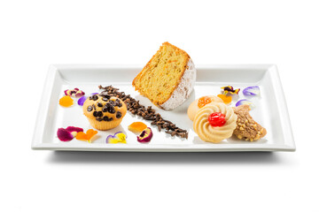 Rectangular plate with biscuits, muffins and soft carrot cake