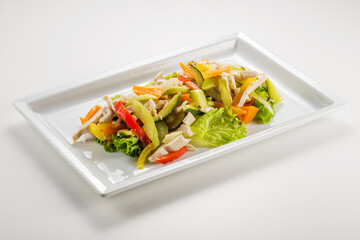 Rectangular plate with chicken salad and vegetable julienne