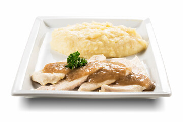 Rectangular plate with slices of white meat and mashed potatoes