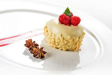 White round plate with small white Sacher with raspberries