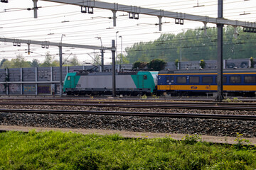 Traxx locomotive with container freight at railroad in Barendrecht