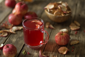 Apple compote in glass on wooden table with dried and fresh apples. Autumn still life