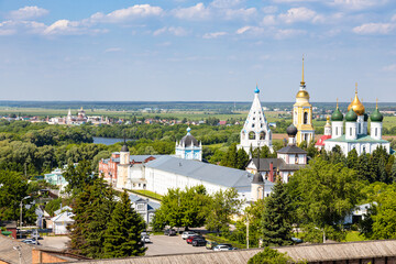 Fototapeta na wymiar above view of churches and cathedral in Kolomna Kremlin and Bobrenev Monastery in Old Kolomna city on summer day from bell tower Church of St John the Evangelist