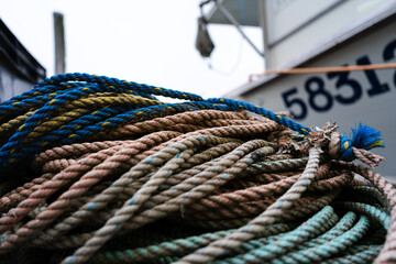 A closeup of knotted rope on a dock used on a fishing boat in Maine