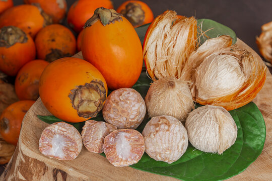 Betel nut or areca nut with betel leaf isolated on wooden background.