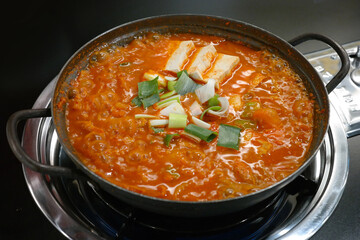 Over-fermented kimchi boiled with pork, bean curd, and green onion. Often considered Korean “soul food,” this spicy kimchi stew strikes a perfect balance with the greasy pork.