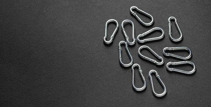 4mm climbing carabiner isolated against a dark background