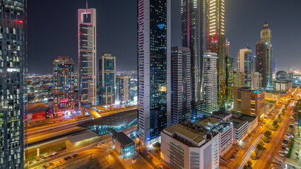 Fototapeta na wymiar Aerial view of Dubai International Financial District with many skyscrapers night timelapse.