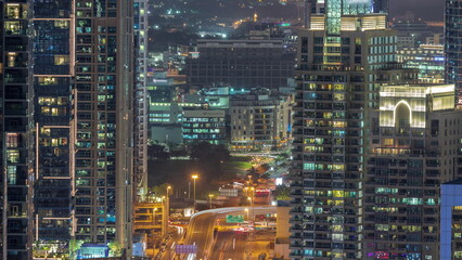 Fototapeta na wymiar Dubai Marina and Media City districts with modern skyscrapers and office buildings aerial night timelapse.