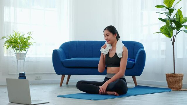 Slow motion, Beautiful young asia woman doing sports and fitness training at home. female exercises on yoga mat in living room. Healthy lifestyle. stretching, Healthcare with yoga therapy concept.