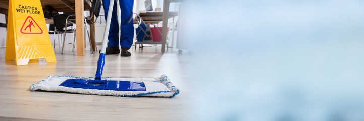 Janitor Cleaning Floor In Office