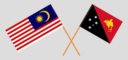 Crossed flags of Malaysia and Papua New Guinea. Official colors. Correct proportion