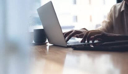 Man hands typing on laptop computer keyboard, close up. E-business, online job. Business man...