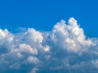 Naklejka na ściany i meble Cumulonimbus cloud under blue sky. Close-up