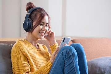 relax, de-stress, holiday, happy, Asian woman relaxing at home listening to music from smartphone and laptop happily.