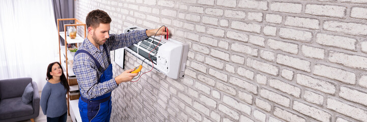 Technician Examining Air Conditioner With Digital Multimeter