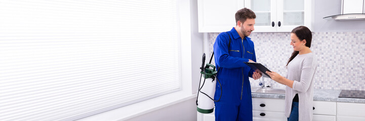 Pest Control Worker Showing Invoice To Woman