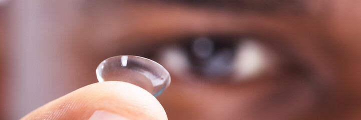 Man Holding Contact Lens In His Finger