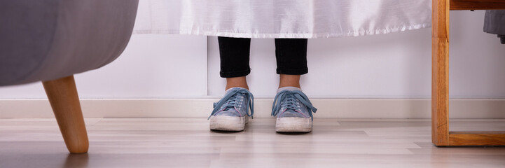 Girl's Feet Behind The Curtain
