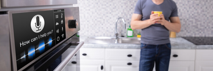 Man Looking At Oven With Voice Recognition Function