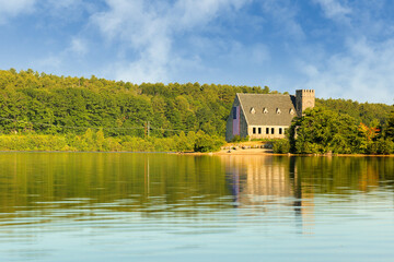 Naklejka na ściany i meble The Old Stone Church and Wachusett Reservoir at West Boylston at sunrise, Massachusetts. The Church, built in 1891, is a historic building in Boylston and is a National Resisted Historic Place. 