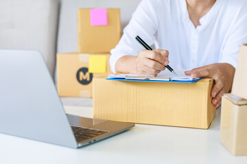 Entrepreneurs are packing boxes at home, Small business selling ideas for sme, Pack products to...