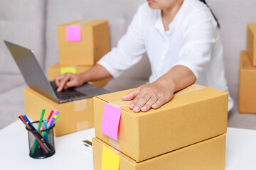 Entrepreneurs are packing boxes at home, Small business selling ideas for sme, Pack products to send to customers.