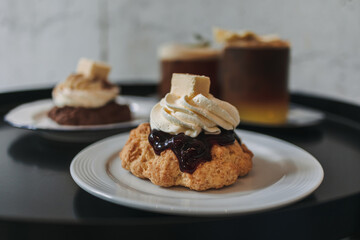 Dessert set of scones and americano coffee for couple served in cafe.