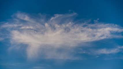 Unusual white cloud in blue sky