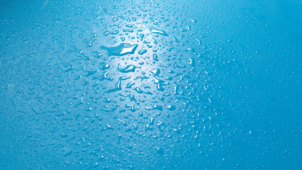 water drops on the blue table - obrazy, fototapety, plakaty