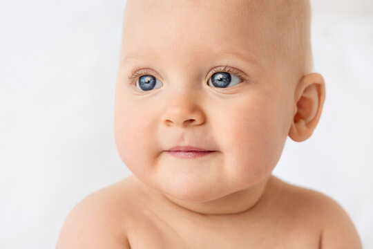 Close-up portrait of cute baby girl with blue eyes