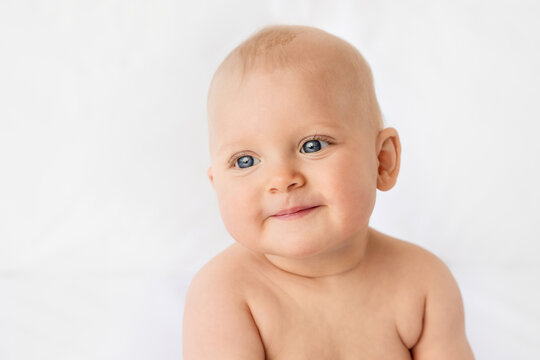 Portrait of smiling baby girl with blue eyes