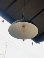 A black and white lamp hangs on the outside wall.