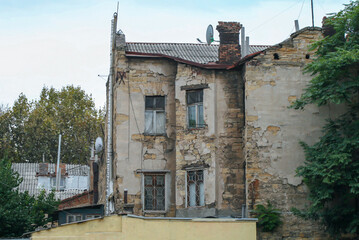 Old dilapidated sandstone building in Art Nouveau style in the Odessa courtyard