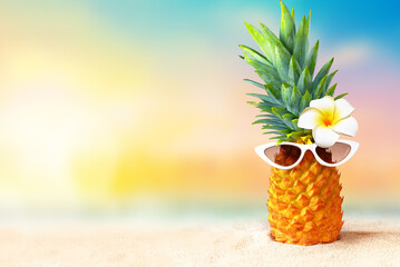 Pineapple with sunglasses on tropical beach background. Summer beach concept. © Belight