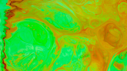 Abstract green-orange fluid art background. Backdrop with abstract mixing paint effect. Liquid surface with blurry paint spots