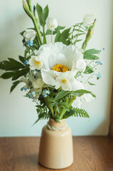 Bouquet of flowers in a vase, peony, forget-me-nots, bluebells, fern
