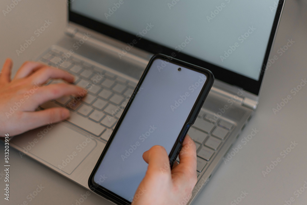 Fototapete top view mockup image of hands holding a blank white screen mobile phone with laptop computer and ta