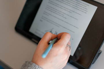 Close up businessman hand electronic Signature on Tablet by Stylus. Write business agreement of contract. Man signing contract on tablet. Business and technology concept